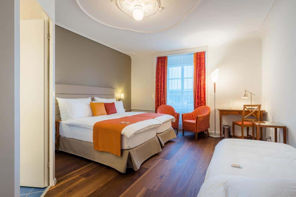 Warm hotel room with double bed and sitting area