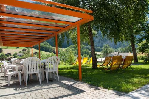 Outdoor seating area with plastic chairs and sun loungers