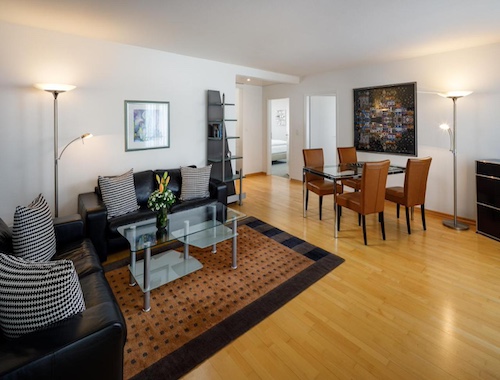 Modern living room with glass tables and dining area