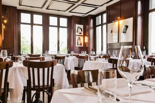 Elegant restaurant with white tablecloths and framed art