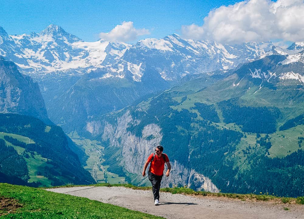 Man hiking Wengen to Männlichen trail in Swiss Alps, best hikes in Lauterbrunnen