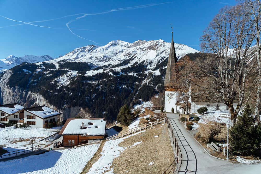 Wengen village church and snow-covered mountains