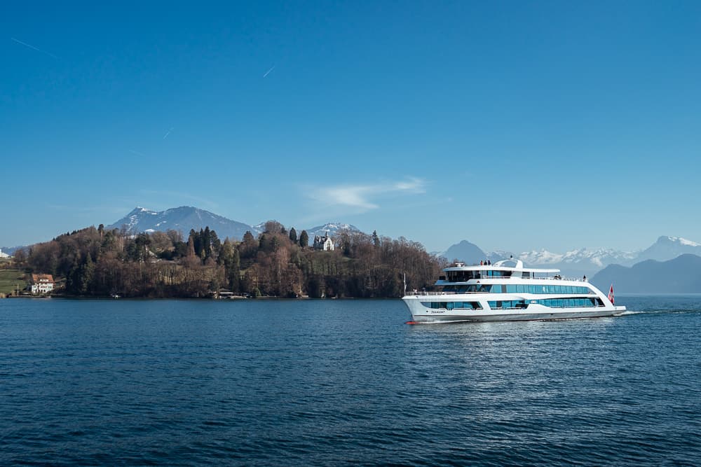 Modern ferry cruising on Lake Lucerne with Alps