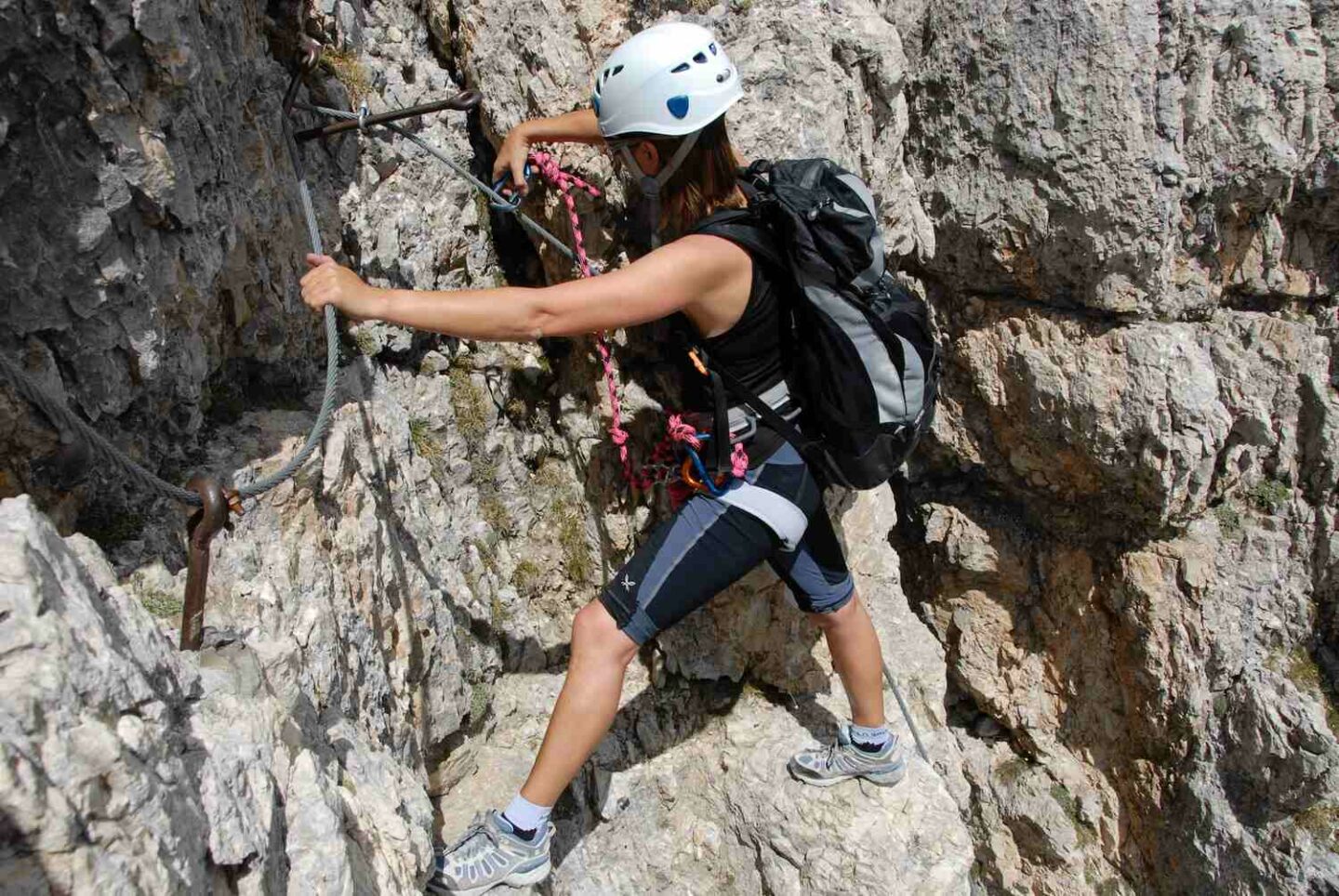 Woman climbing Via Ferrata near Lauterbrunnen cliffs