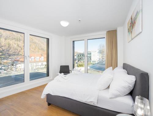 Minimalist hotel room with a view through floor-to-ceiling windows