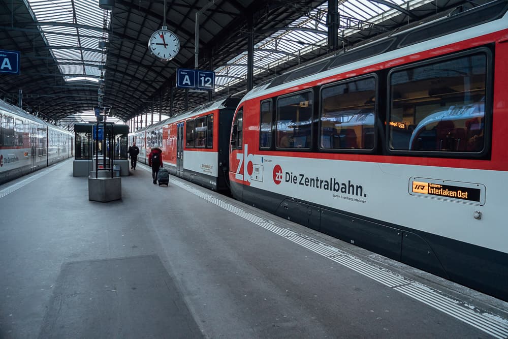 Interlaken train station platform with red Zentralbahn train