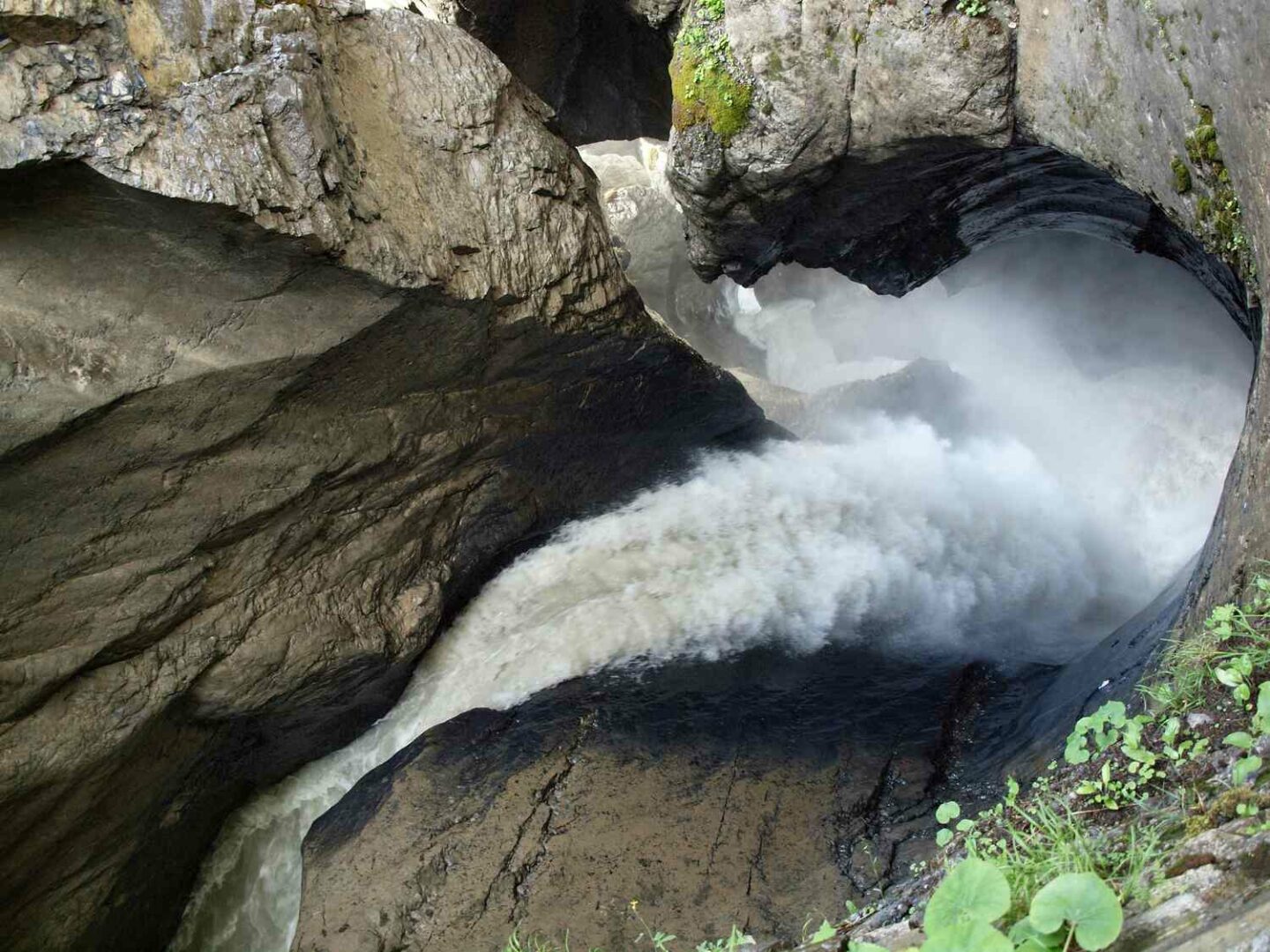Water rushing through rock tunnel at Trümmelbach Falls